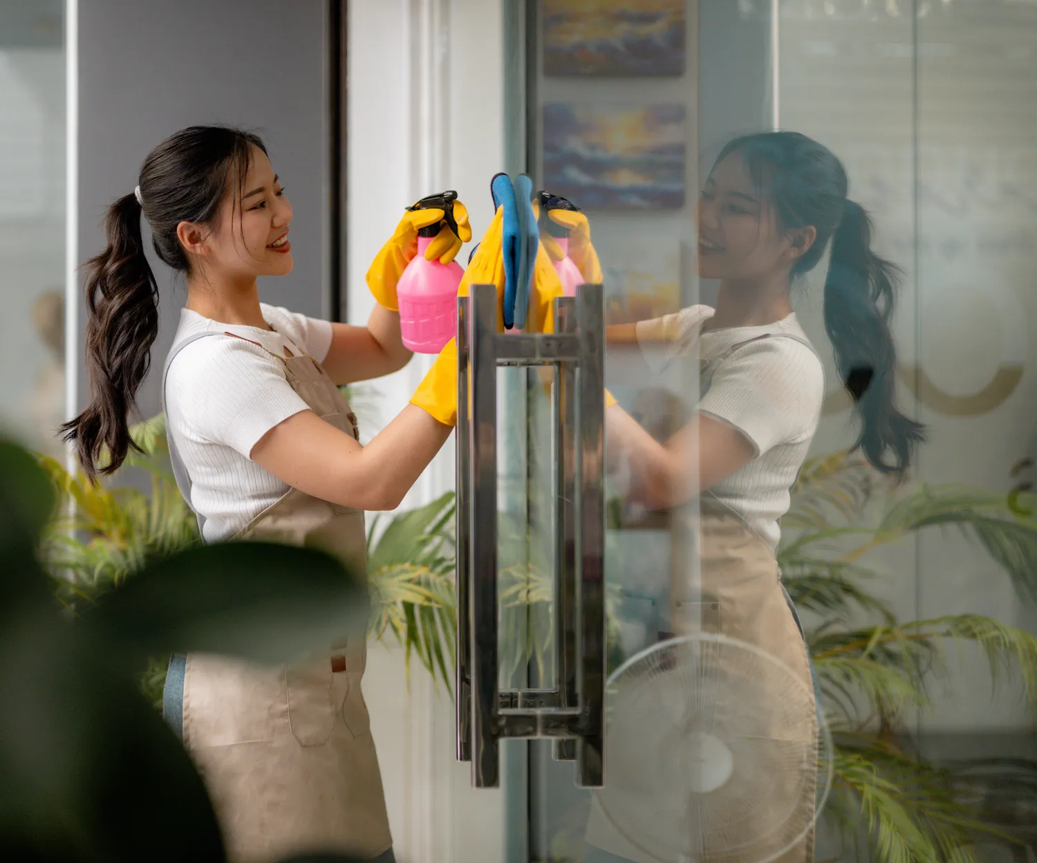 Max Pflughaupt - Hausmeisterservice - Professioneller Reinigungsdienstmitarbeiter beim Fensterputzen in einem Bürogebäude